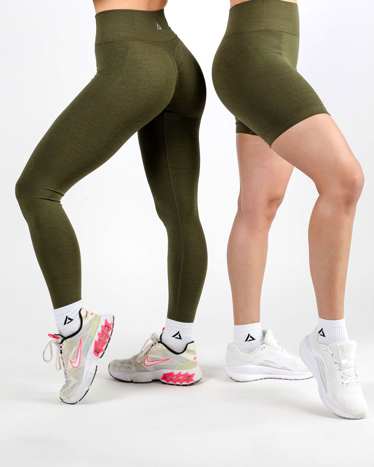 Two models in the Army Green Shorts, emphasizing the figure-hugging look and seamless comfort for ultimate freedom.