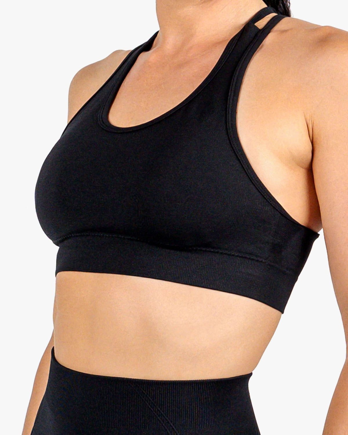 Close-up of the matte black performance fabric of the high-impact sports bra, featuring sweat-wicking technology.