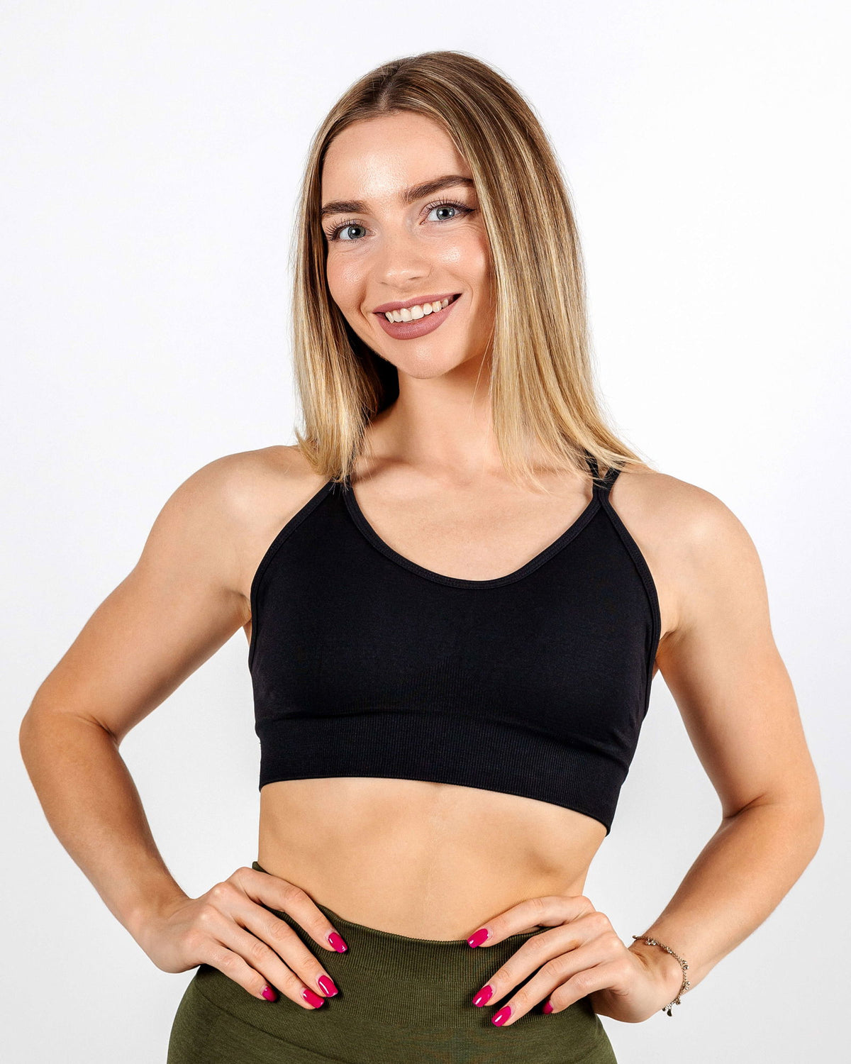 Black Multi-Strap Seamless Sports Bra with a sleek matte finish and flattering neckline for light-to-medium support.