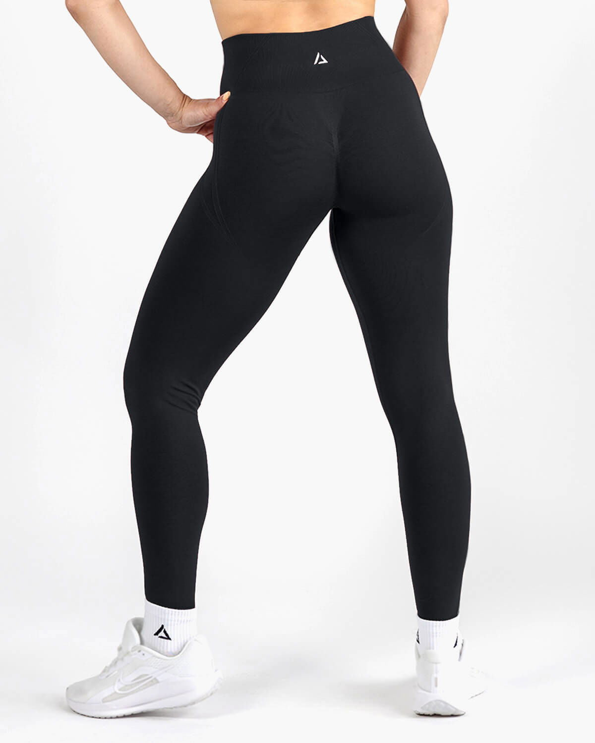 Back view of black seamless leggings showing sculpted support fit.