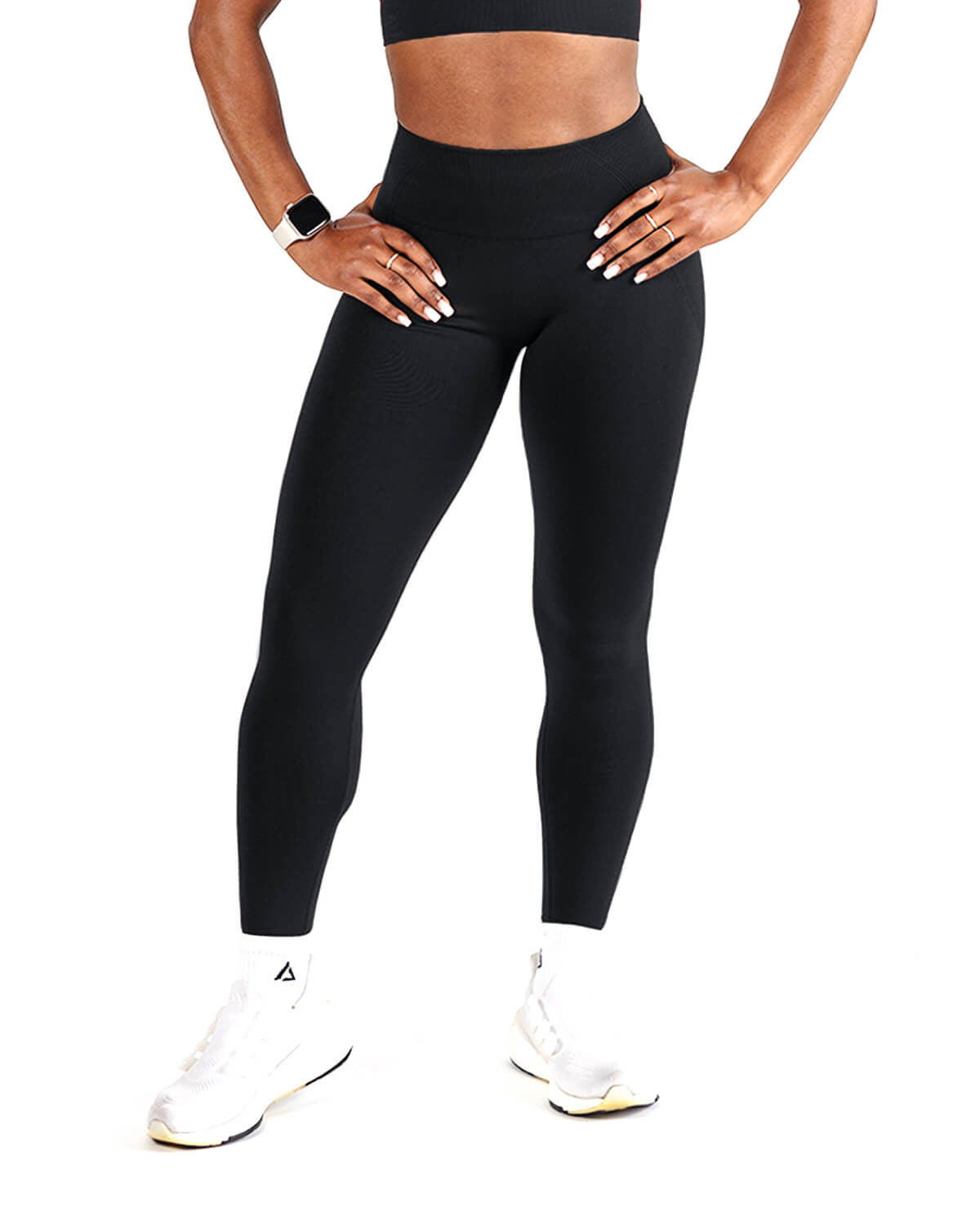 Front view of woman wearing black seamless leggings, high waist support.