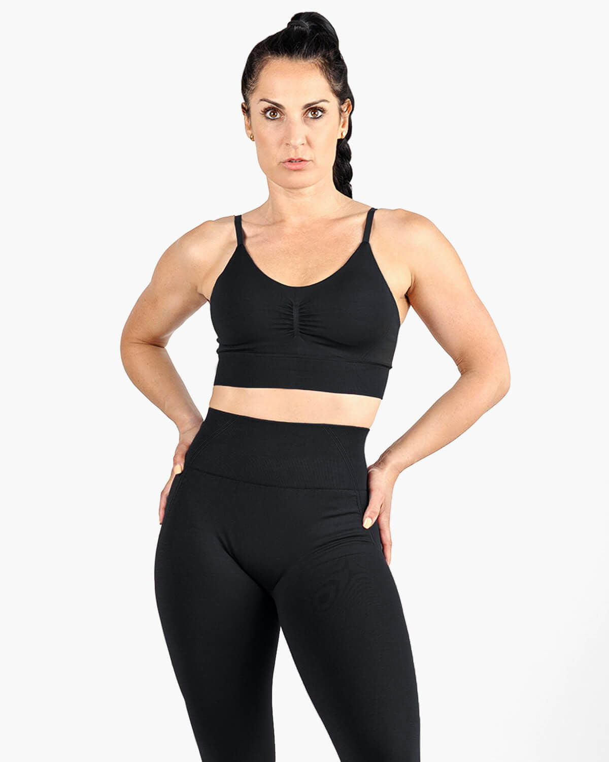 High support sports bra styled with seamless leggings, activewear look.