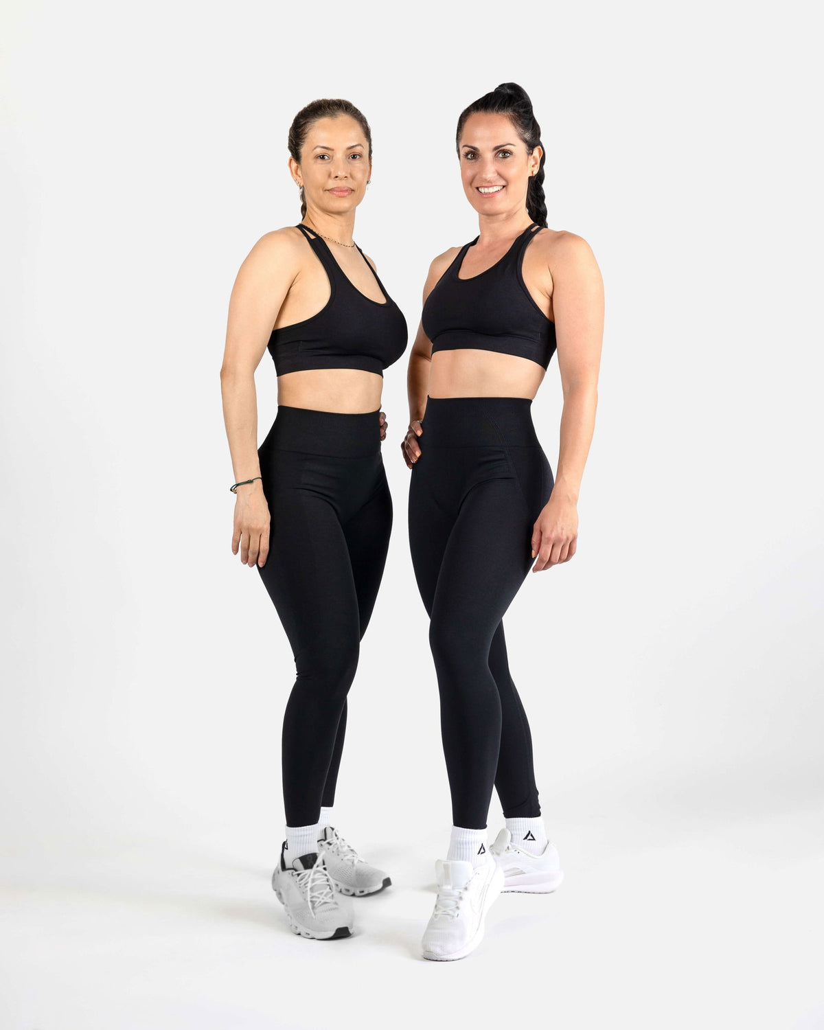 Two models wearing the Dellauera Black Active Bra and Leggings set, perfect for high-intensity training.