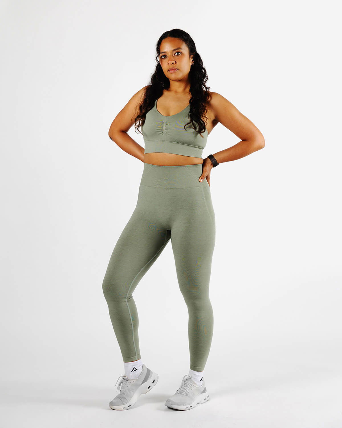Full body shot of Dellauera High Support Sports Bra in Sage Green with matching leggings, highlighting the sculpting fit for training and recovery.