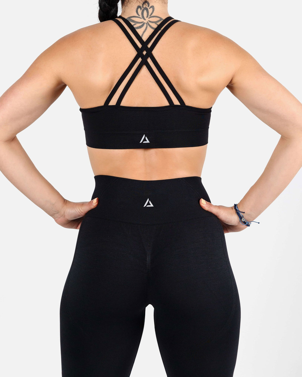 Back view showing dual cross-strap design of black high-impact sports bra