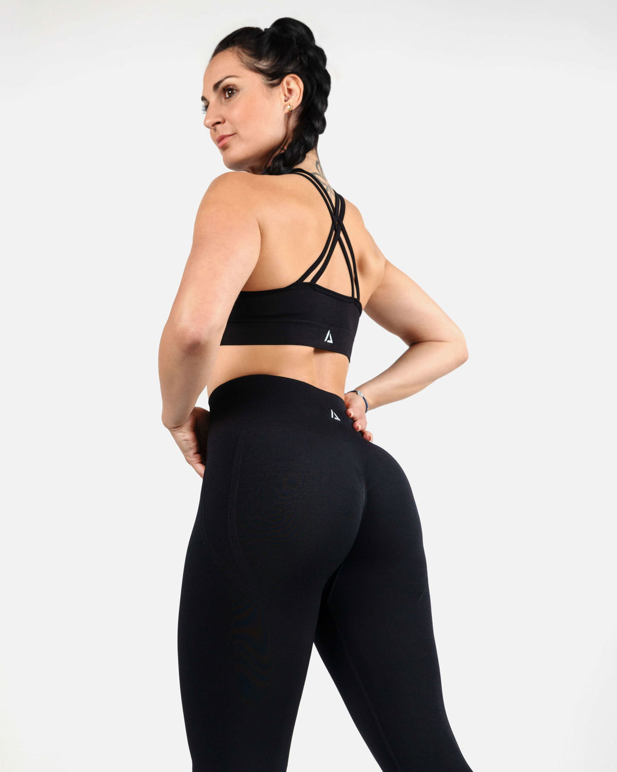 Side view of women’s seamless black sports bra for high-intensity training.