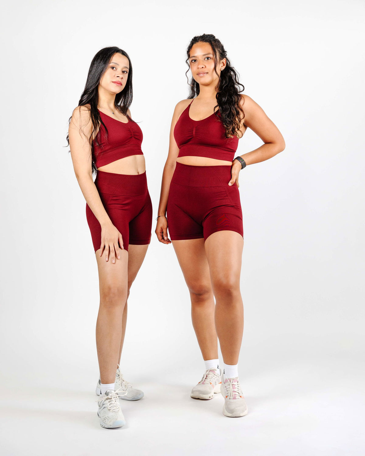 Two models wearing the Red Scrunch Sports Bra and leggings, showcasing the bold tone and sculpting fit for style and performance.