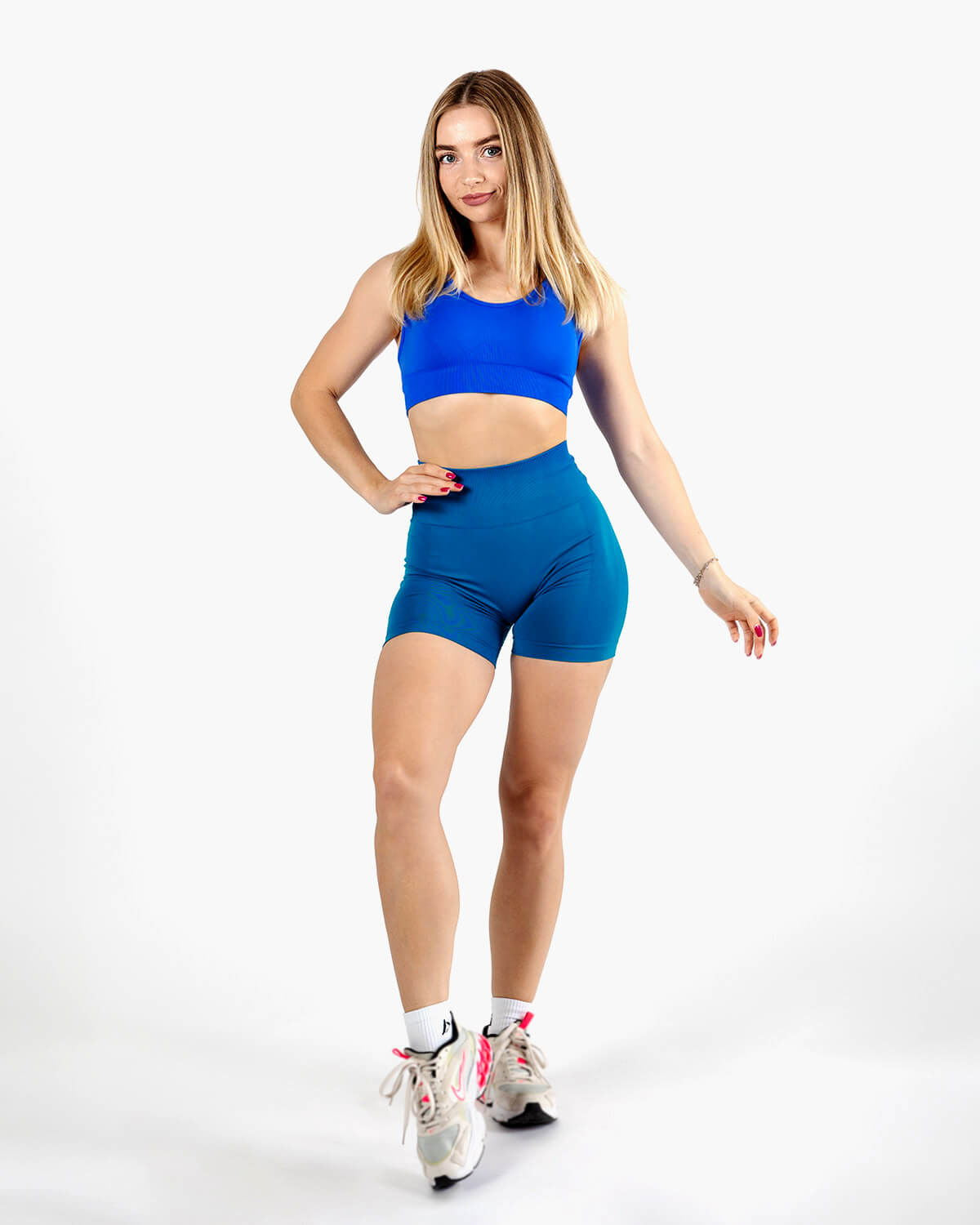 Full body shot of the Wave Blue activewear set, pairing the seamless shorts with the Dual Cross Strap Active Bra.