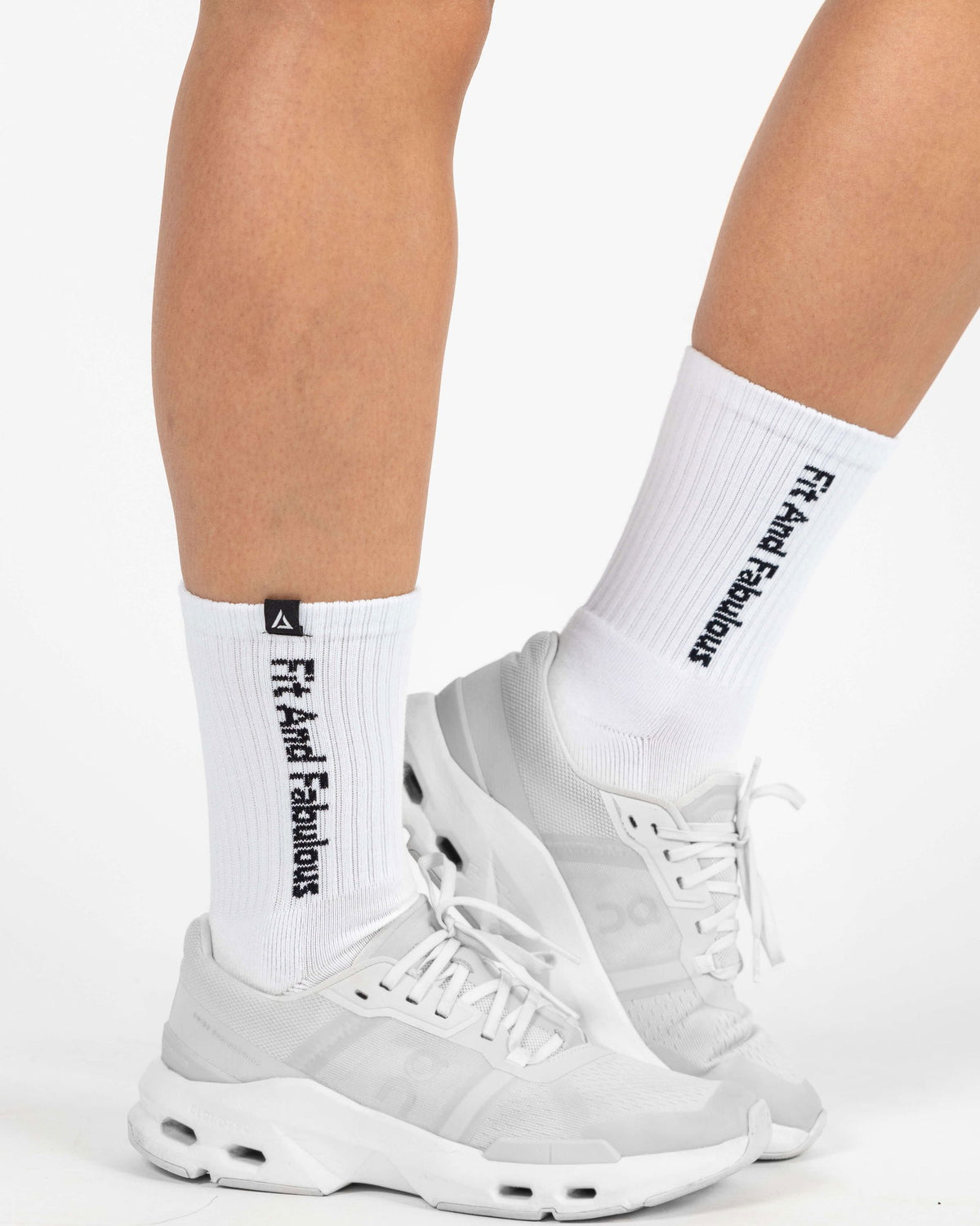 Model wearing white Dellaura crew socks during active movement.